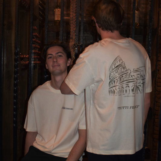 Two men wearing the Fortissimo Colosseo t-shirt in creme where the Colosseo is showing on the back.