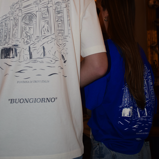 The oversized Fortissimo shirt showing the back print accompanied by the other color available in this print. The blue with a creme print.