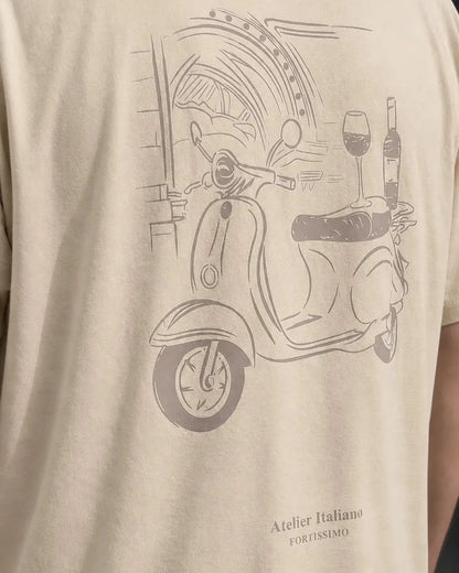 Beige t-shirt with a scooter graphic and text on a person wearing it.